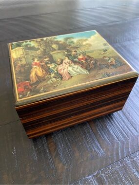 Vintage Reuge Sainte Croix music box with a painted lid and striped wood